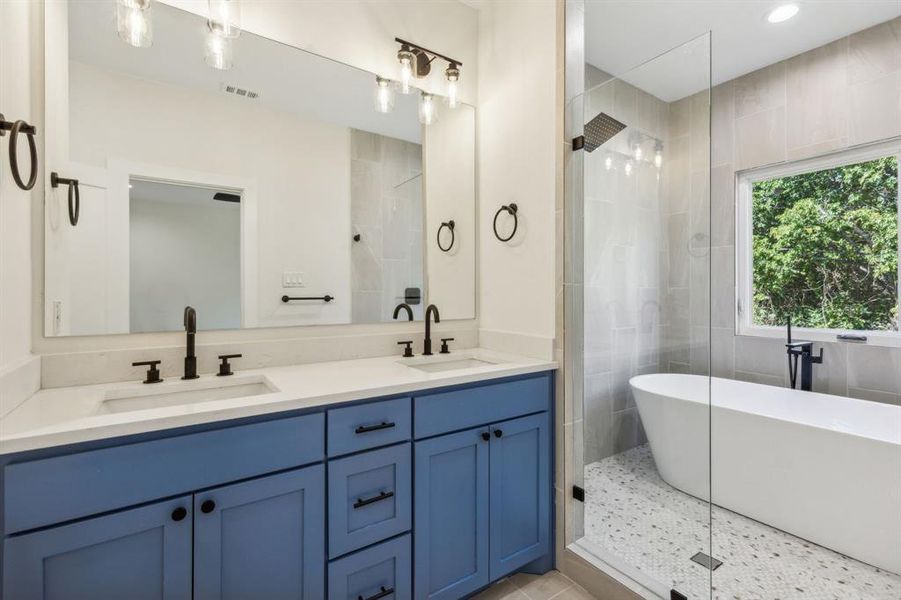 Primary ensuite bath featuring double vanities.