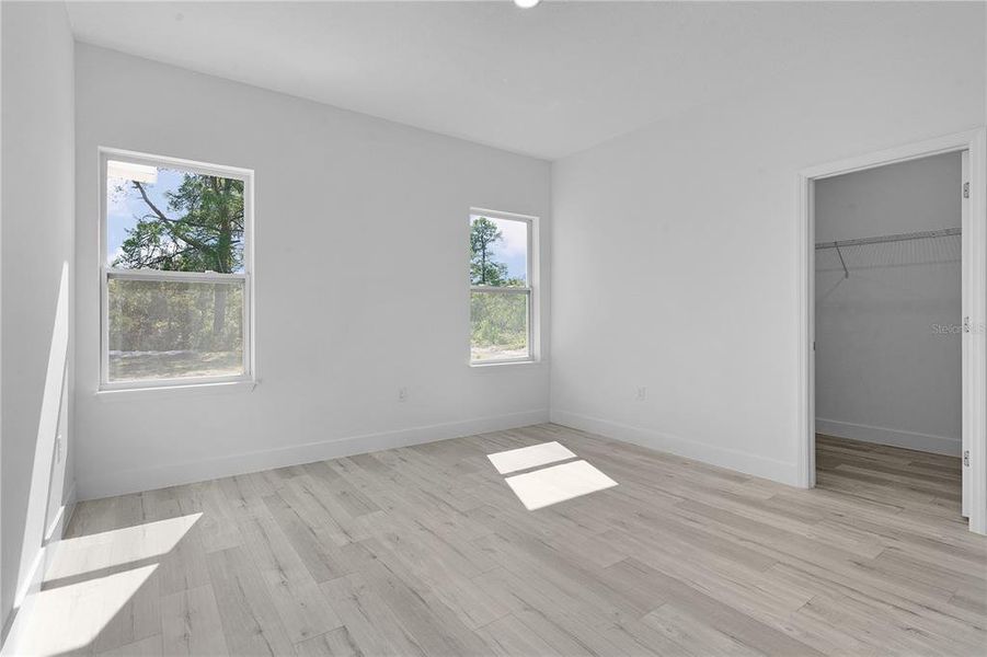 Primary bedroom on the rear of the house, with door to the walk-in closet