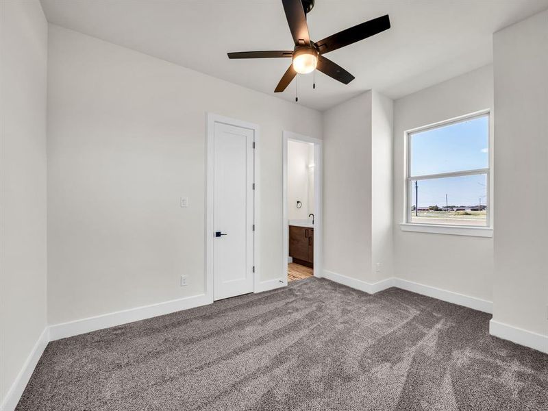 Unfurnished bedroom with carpet and ceiling fan