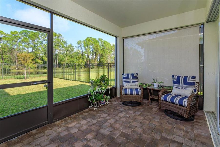 Screened-in, covered lanai with pavers