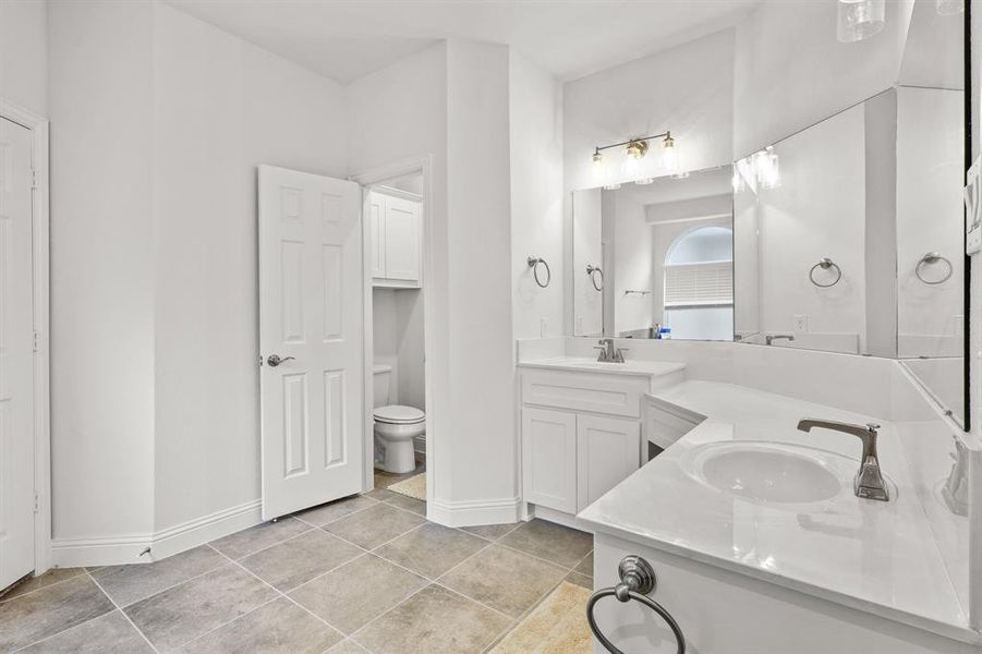 Bathroom with tile patterned flooring, vanity, and toilet