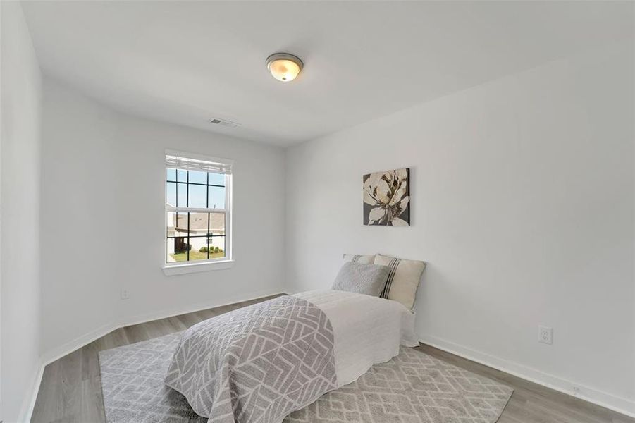 Bedroom with light hardwood / wood-style floors