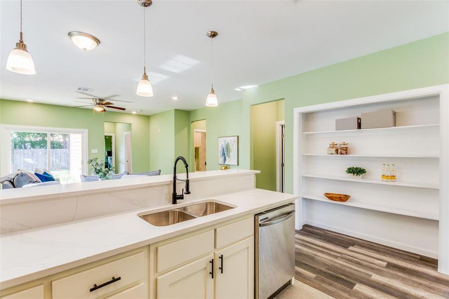 Kitchen with hardwood / wood-style floors, sink, pendant lighting, dishwasher, and ceiling fan