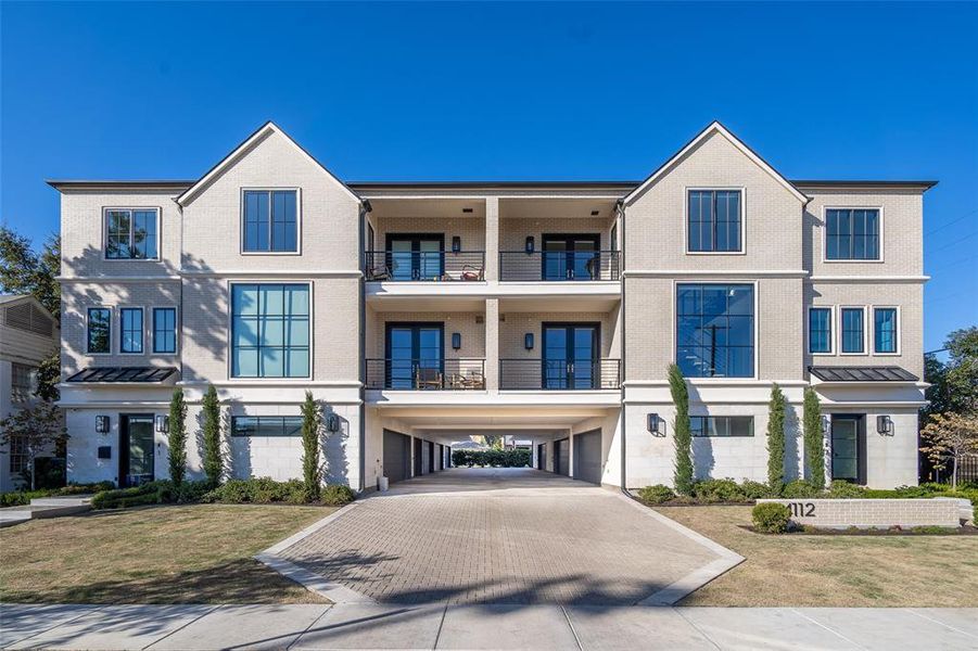 Multi unit property with a balcony, a front yard, and a carport