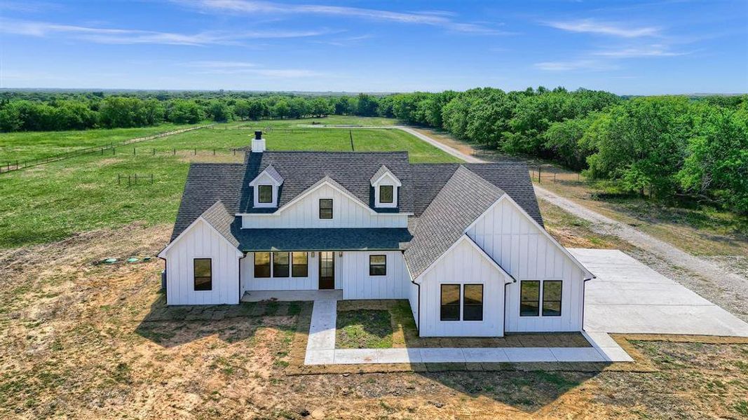 Modern inspired farmhouse with a front yard