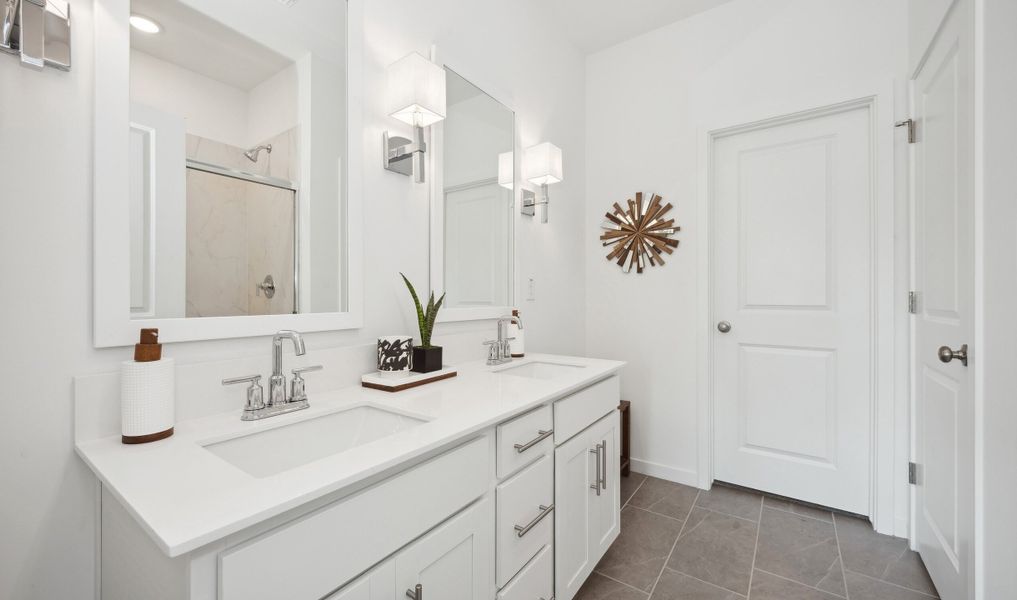 Primary bath with dual sinks and chrome fixtures throughout