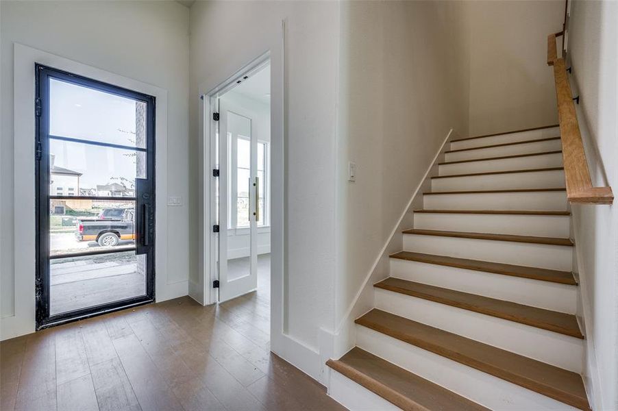 Entryway featuring a wealth of natural light and hardwood / wood-style flooring