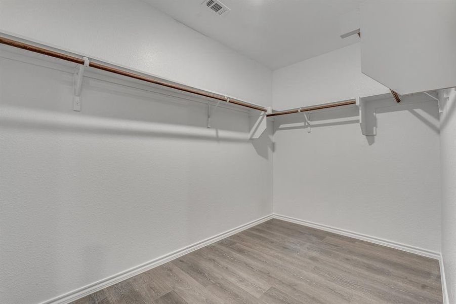 Spacious closet featuring light wood-type flooring