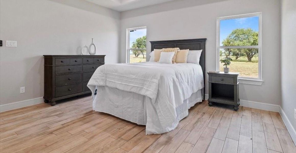 Bedroom featuring light wood-type flooring and multiple windows