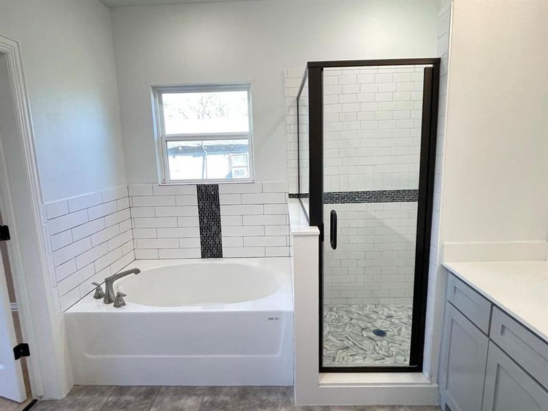 Bathroom with vanity and plus walk in shower