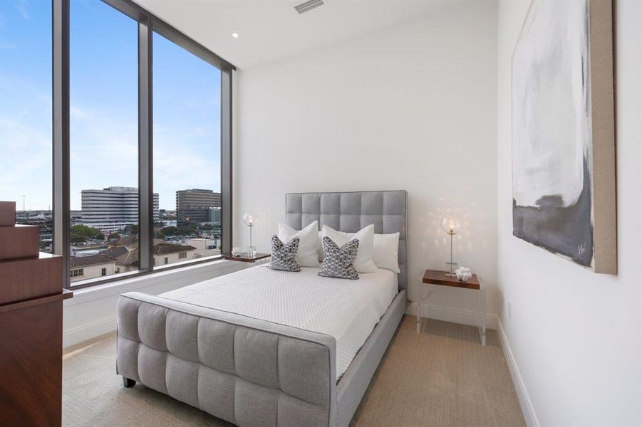 Secondary en-suite bedroom also enjoys the same tall ceilings, recessed lighting and south facing views towards the Houston Medical Center.