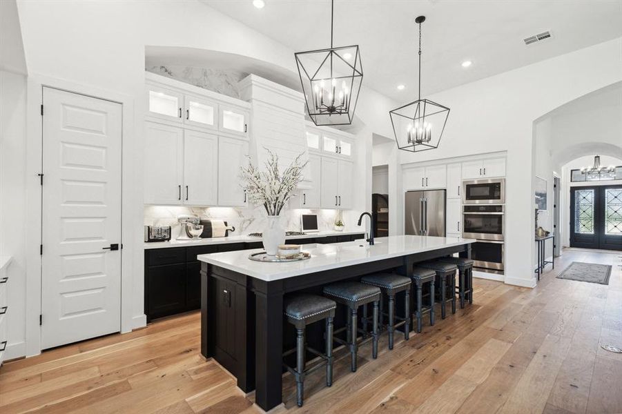 Boasting chic cabinets to the ceiling, there is an overflow of storage possibilities in the kitchen.