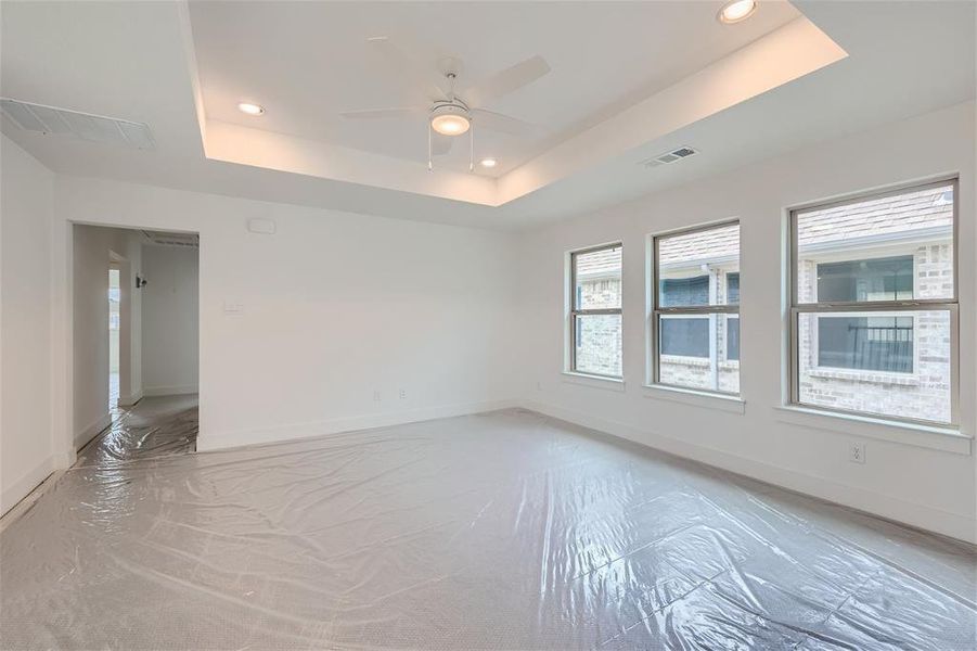 Game room featuring a tray ceiling and ceiling fan