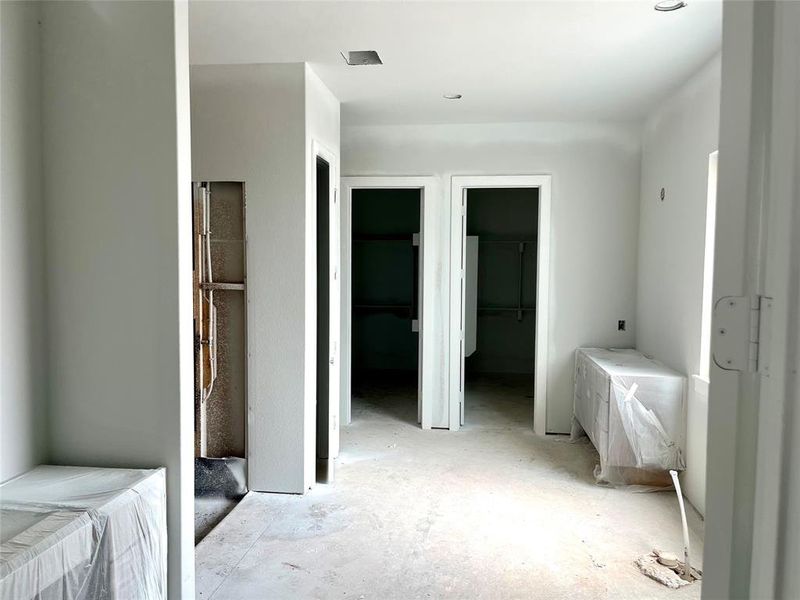 Primary bath with split vanities, a 67” soaking tub and an oversized shower. 2 closets complete the space.