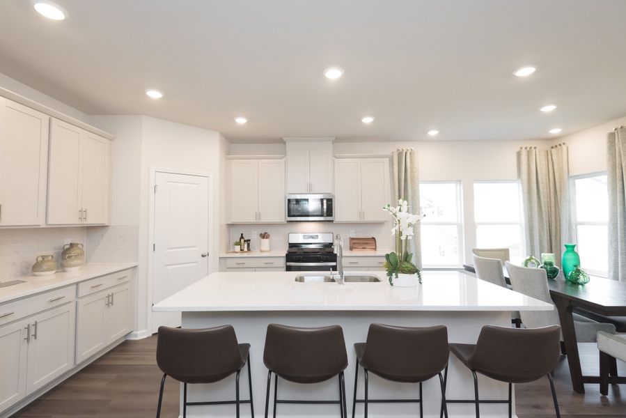 The spacious kitchen island overlooks the dining area and great room.