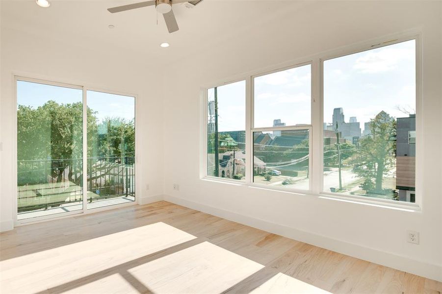 Unfurnished sunroom with ceiling fan and plenty of natural light