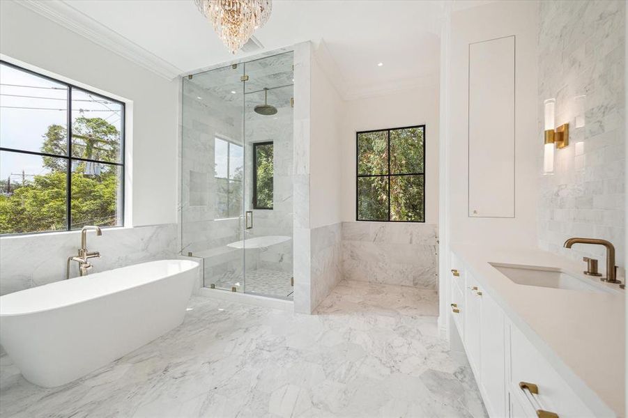 The first of two stunning primary bathrooms combines marble finishes with an exquisite soaking tub, creating a spa-like retreat. With a spacious walk-in shower and a vanity designed for comfort, you can enjoy tree-top views while pampering yourself in style.