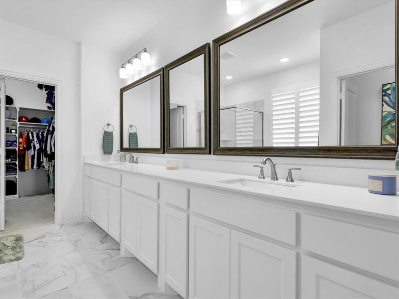 Primary bathroom with dual vanity and tile patterned floors