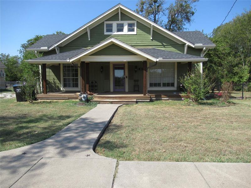 View of front of property porch and a front lawn