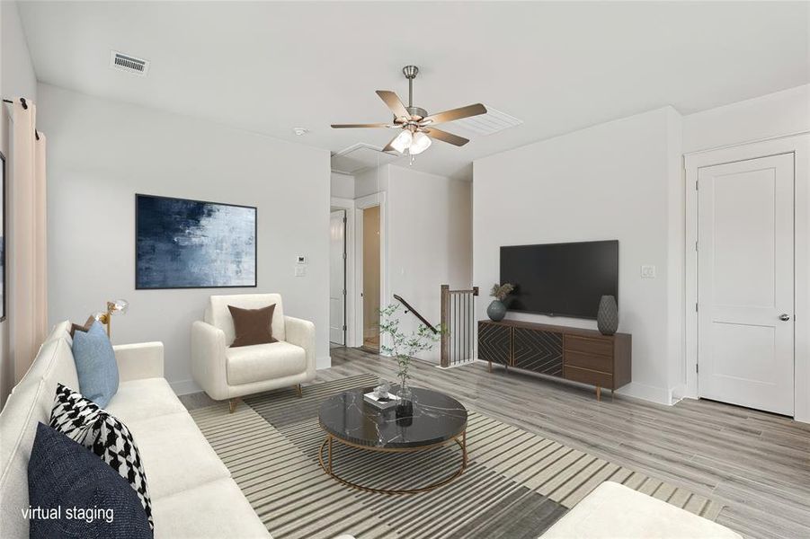 Living room with light hardwood / wood-style flooring and ceiling fan