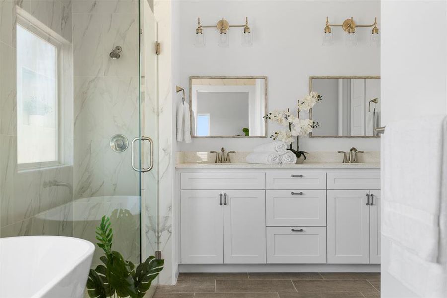 Bathroom featuring vanity, a healthy amount of sunlight, and shower with separate bathtub