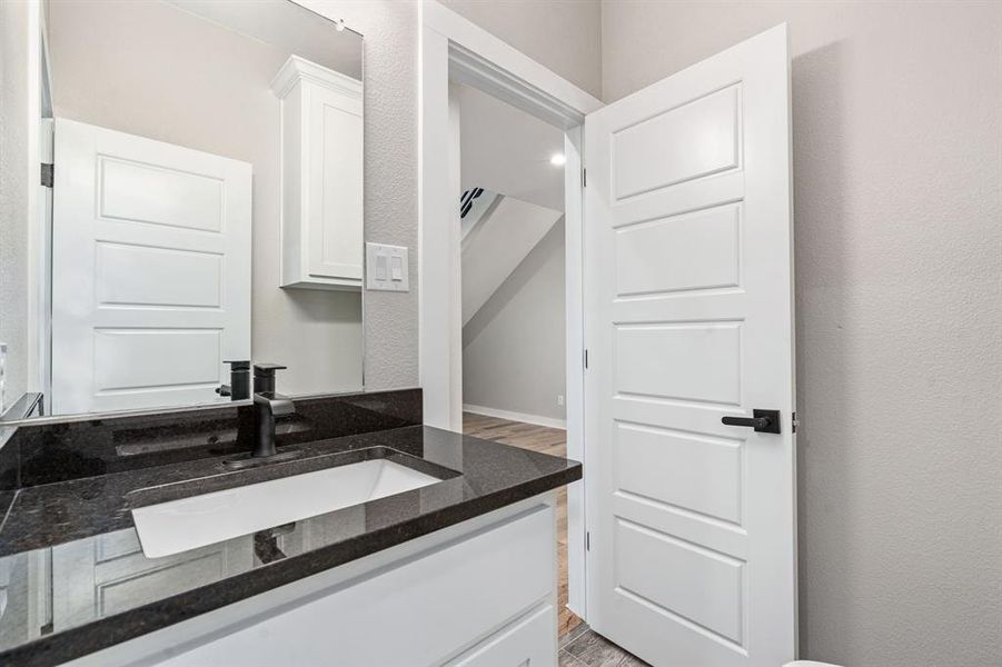 Bathroom with vanity and hardwood / wood-style floors