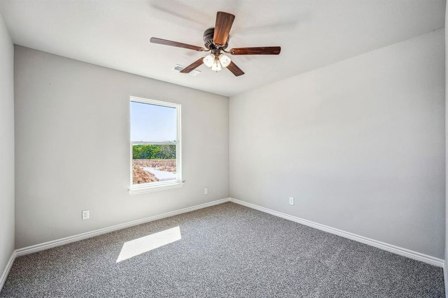 Bedroom 2 with ceiling fan and carpet flooring