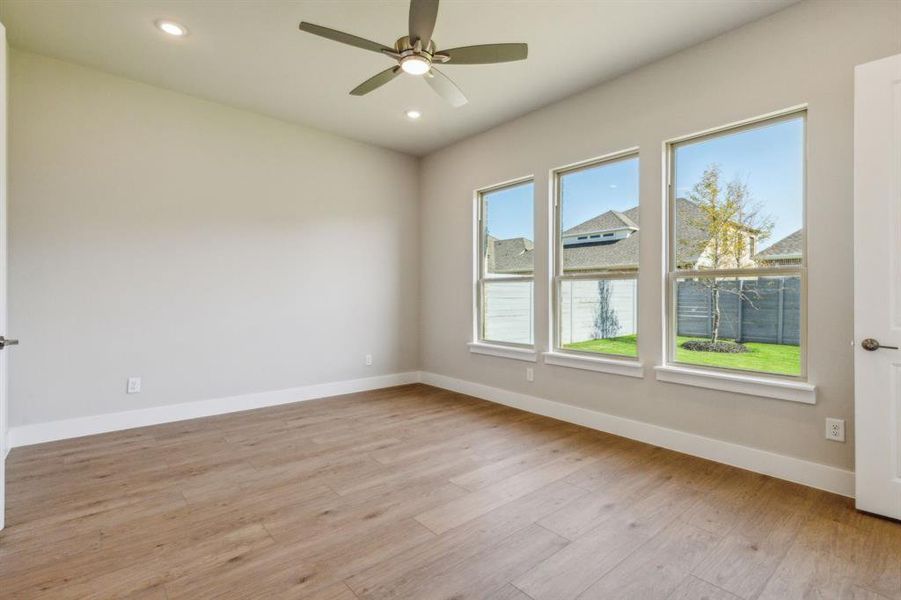 Unfurnished room with light wood-type flooring and ceiling fan