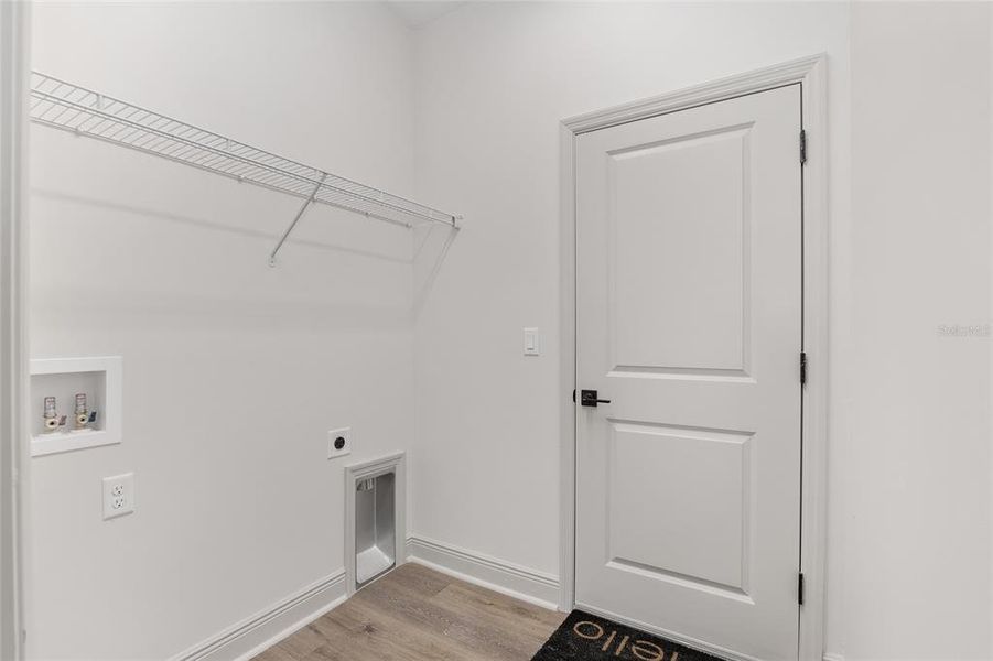 Laundry Room with Shelving, 9' Ceiling and Luxury Vinyl Plank Flooring