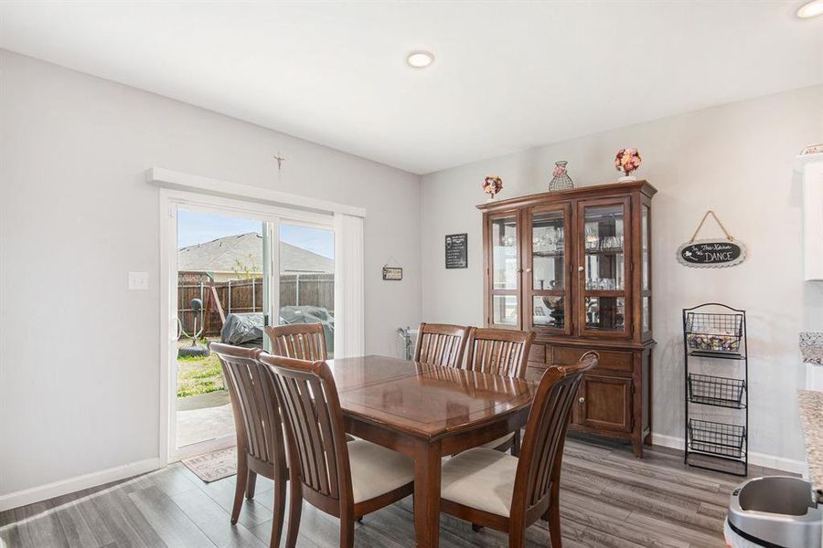 Dining space with hardwood / wood-style floors