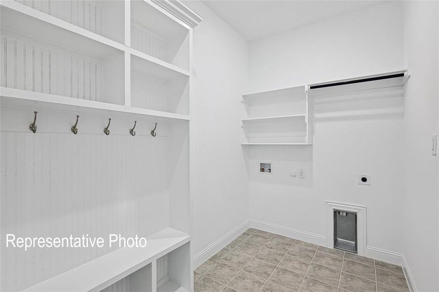 Washroom featuring gas dryer hookup, hookup for an electric dryer, hookup for a washing machine, and light tile floors