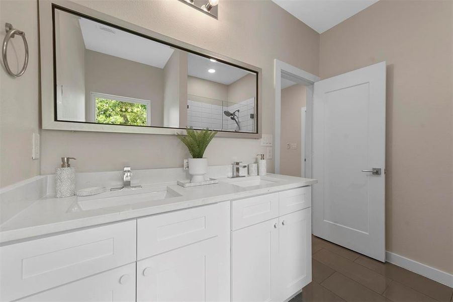 Bathroom with vanity and a shower