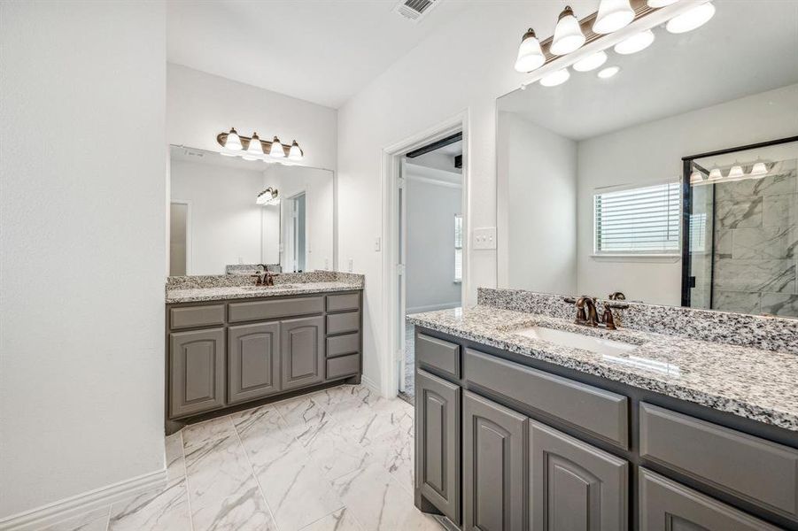Bathroom featuring tile patterned flooring and dual bowl vanity