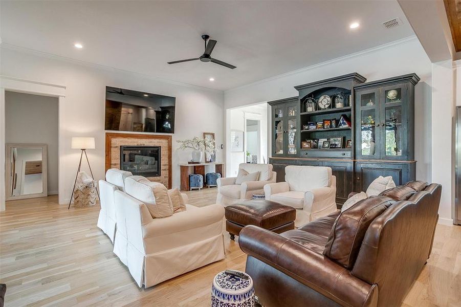 The living room exudes warmth and character, centered around a striking brick fireplace.