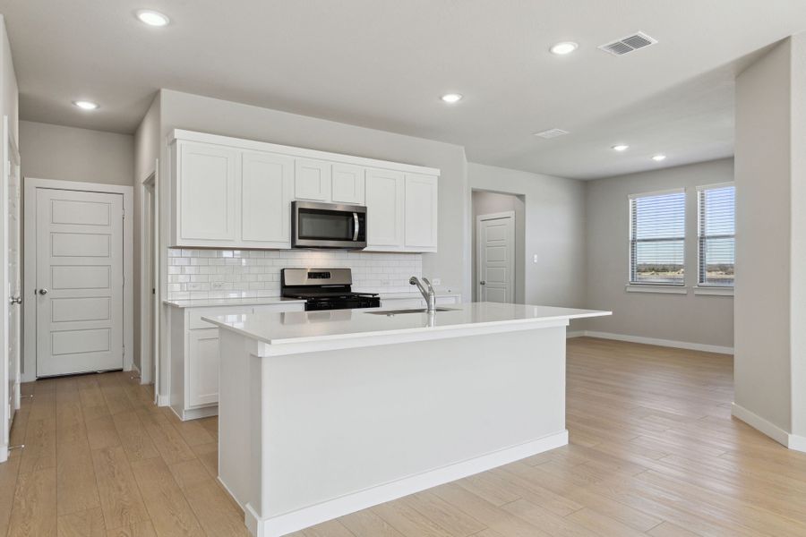 Kitchen in the Oak home plan by Trophy Signature Homes – REPRESENTATIVE PHOTO