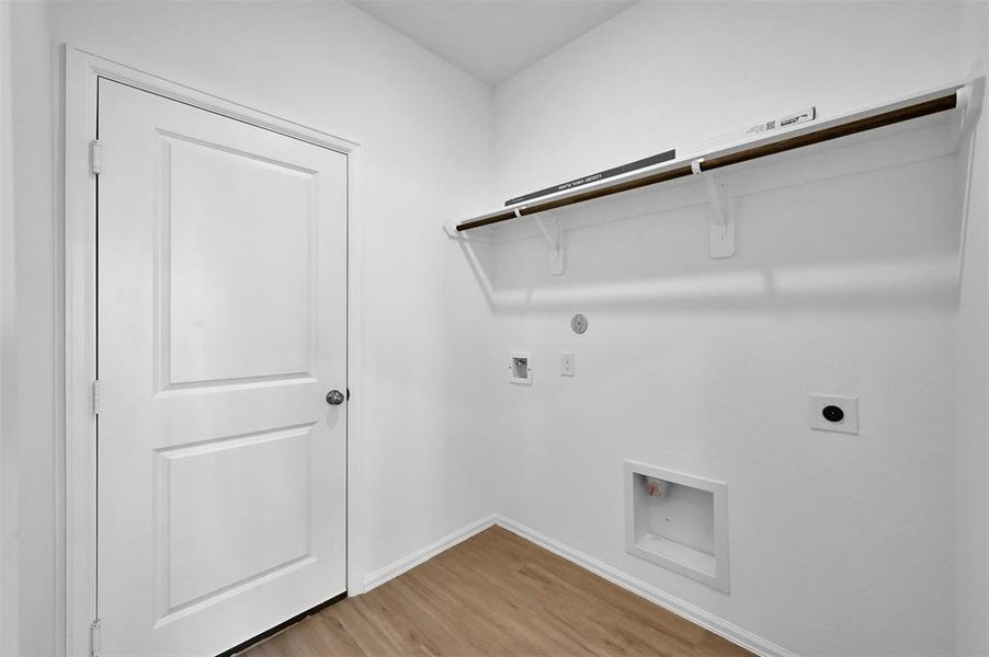 The laundry room is located downstairs with quick access from the garage to the kitchen