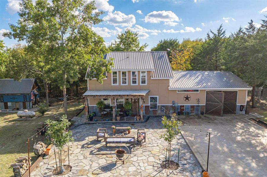 Front of house featuring a patio and a fire pit