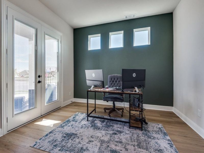 Office space with french doors and light wood-type flooring