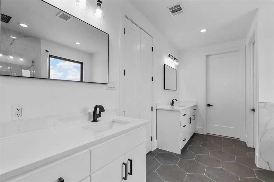 Bathroom featuring double vanity and tile patterned floors