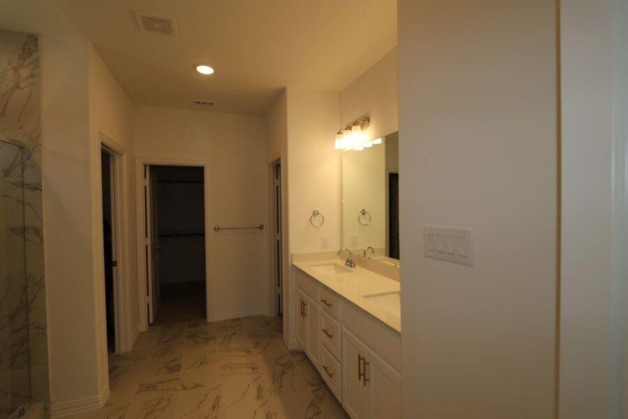 Bathroom featuring walk in shower and vanity