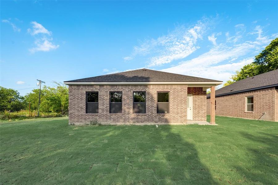 Rear view of property featuring a yard