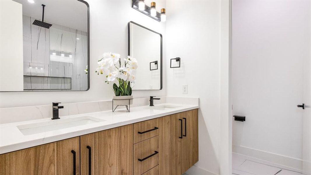 Bathroom featuring tile flooring, oversized vanity, and dual sinks
