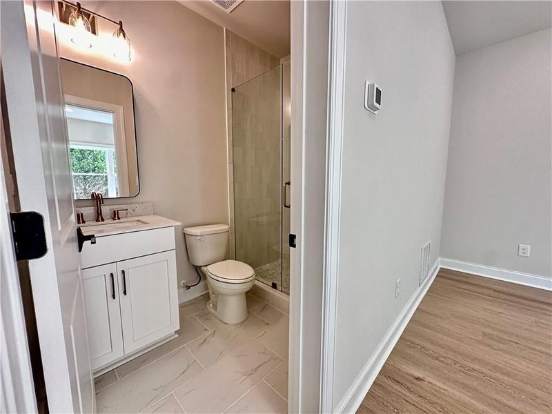 Full bathroom connected to fourth bedroom with upgraded walk-in shower