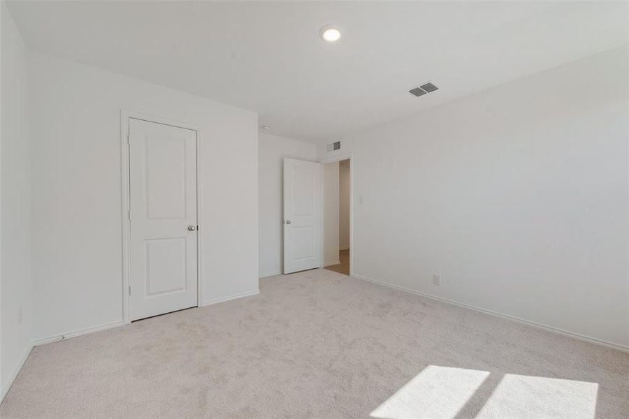 Spare room featuring light colored carpet