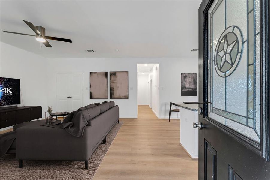 Step inside to a harmonious blend of spaces, where the living room, laundry room, and the kitchen island tantalize with their seamless integration. (Virtual Staging May Be Present)