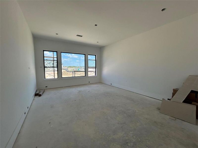 Spacious main bedroom with lots of windows to let light stream in.