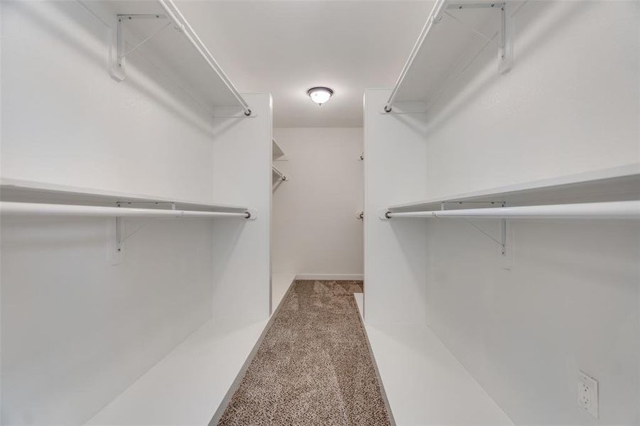 Primary bedroom has this MASSIVE closet with plenty of room for everything. Time to go buy MORE CLOTHES to fill it up!