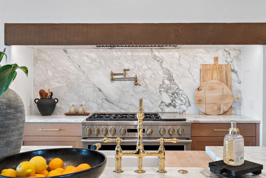 Kitchen with range with two ovens and light stone counters