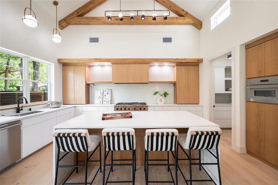 Kitchen featuring a center island, sink, stainless steel appliances, and light hardwood / wood-style floors