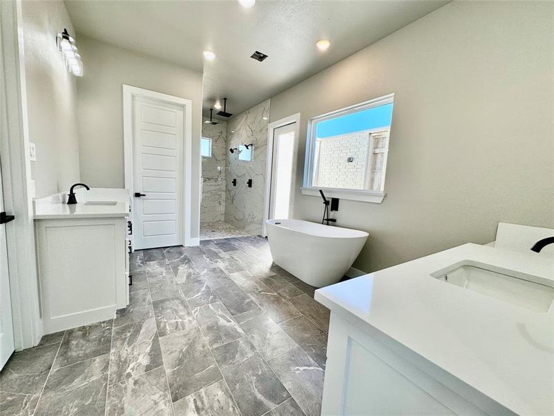 Bathroom featuring plus walk in shower and vanity